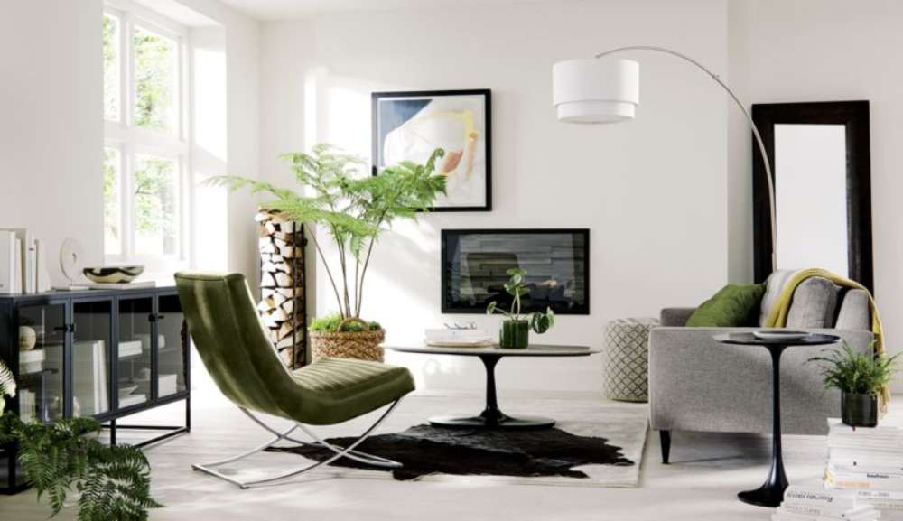 Crate & Barrel Casement 66" Black Credenza sits in a bright living room, providing stylish storage beside modern seating and large windows