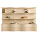 Crate & Barrel Coast 120" Whitewashed Oak Open Storage Bookcase, Set of 3 shown from the front with nine open shelves and six curved storage drawers styled with books and decorative accents
