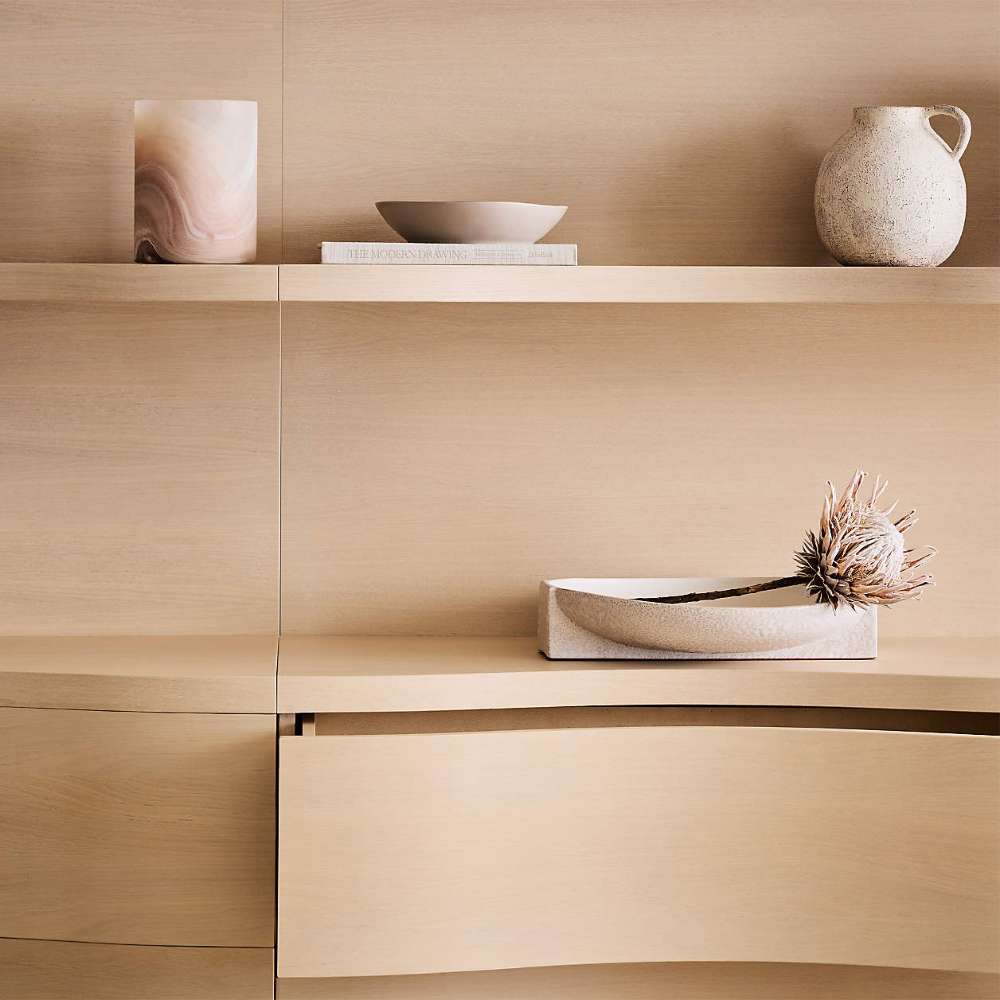 Crate & Barrel Coast 40" Whitewashed Oak Open Storage Bookcase detail showing the curved drawer fronts beneath the open shelving