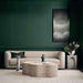 Crate & Barrel Contour Sofa styled in a modern living room with a stone coffee table, decorative pillows, and dark green walls