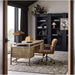 Crate & Barrel Draper Ginger Upholstered Office Chair placed at a light wood desk in a modern home office with black bookcases and a large window