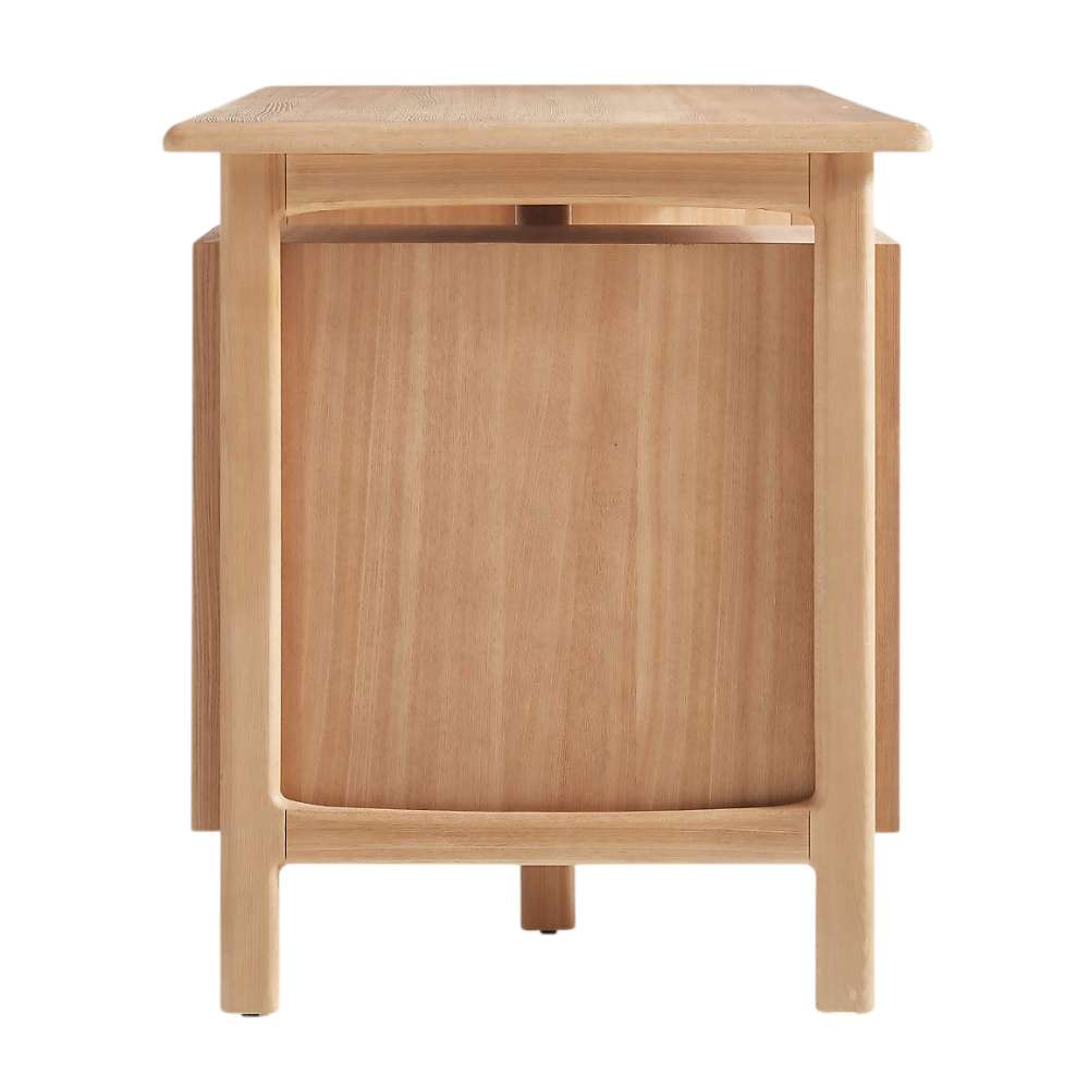 Crate & Barrel Elias 66" Natural Elm Wood Desk with File Cabinet side view highlights its solid wood panel design and rounded frame