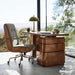 Crate & Barrel Ellison Green Woven High-Back Office Chair at a modern wooden desk with floor-to-ceiling windows and scenic outdoor views