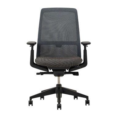 Crate & Barrel Haworth Soji Upholstered Charcoal and Mesh Office Chair front view highlights the breathable mesh back, upholstered seat, and adjustable armrests