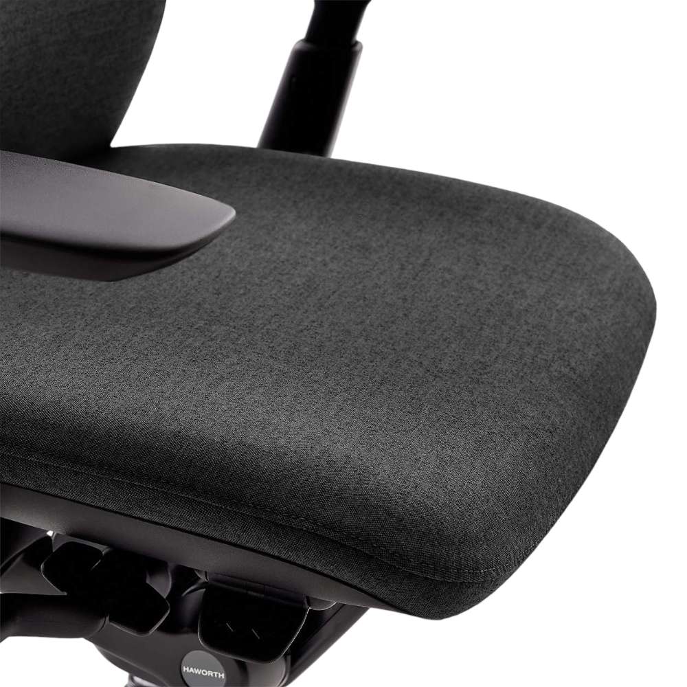 Crate & Barrel Haworth Zody Upholstered Charcoal Office Chair features a close-up of the cushioned seat with soft charcoal fabric upholstery