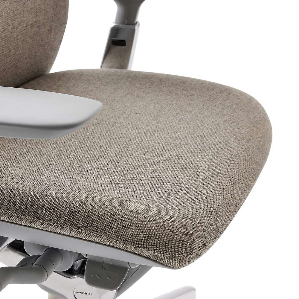 Crate & Barrel Haworth Zody Upholstered Stone Office Chair features a close-up of the cushioned seat with durable textured fabric upholstery