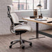 Crate & Barrel Humanscale® Freedom Headrest White Boucle Office Chair placed beside a modern desk in a bright home office with large windows and wood flooring