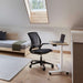 Crate & Barrel Humanscale® World LM Seat Task Office Chair is paired with a compact standing desk in a bright loft bedroom with a skylight