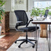 Crate & Barrel Humanscale® World LM Seat Task Office Chair is placed at a wooden desk with a laptop and notebook in a bright home office filled with natural light
