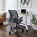 Crate & Barrel Humanscale® World LM Seat Task Office Chair is positioned beside a height-adjustable desk with a laptop in a stylish living room workspace