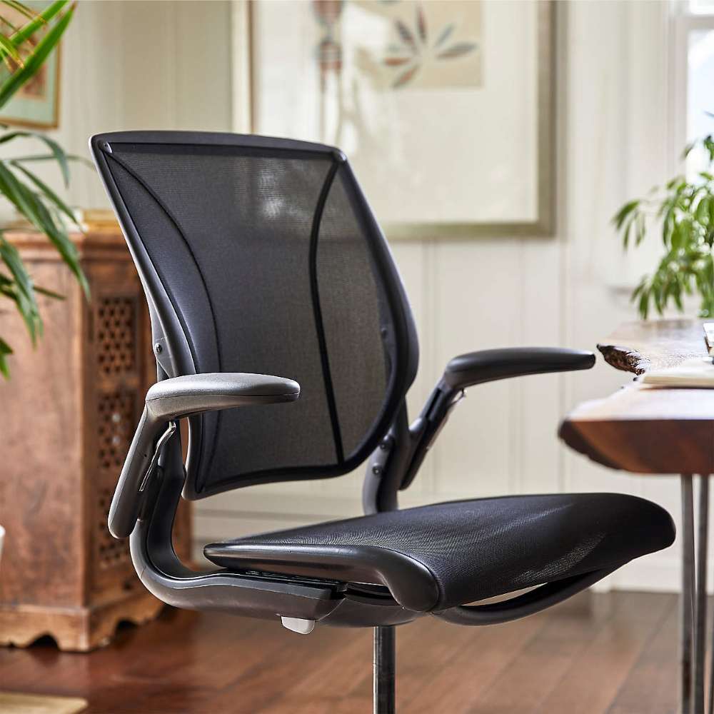 Crate & Barrel Humanscale® World LM Seat Task Office Chair is shown in close-up, highlighting its breathable mesh back, padded seat, and adjustable armrests