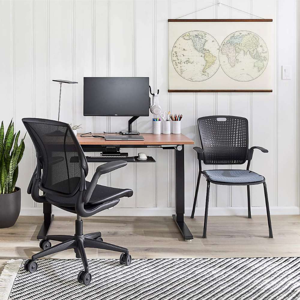 Crate & Barrel Humanscale® World LM Seat Task Office Chair sits at a modern standing desk with a monitor and accessories in a clean, organized home office