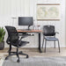 Crate & Barrel Humanscale® World LM Seat Task Office Chair sits at a modern standing desk with a monitor and accessories in a clean, organized home office