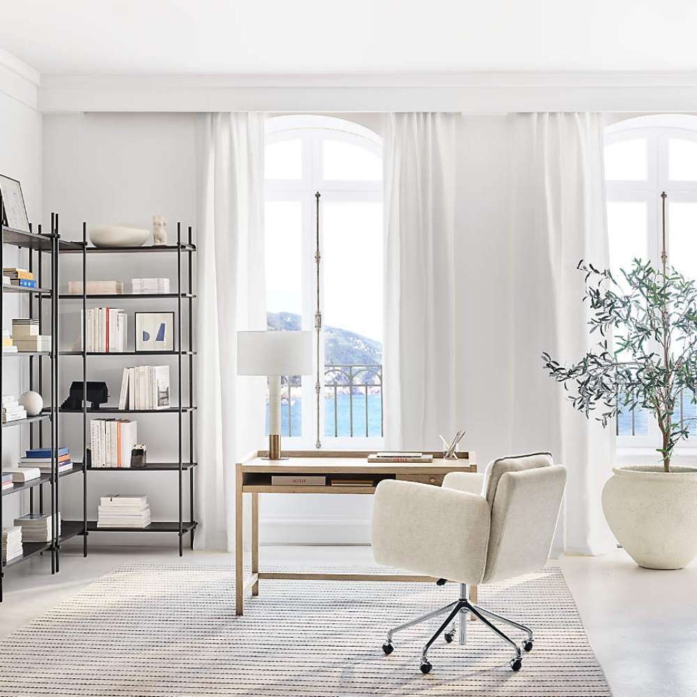 Crate & Barrel Jens Plush Ivory Office Chair styled in a modern home office beside a light wood desk and large windows