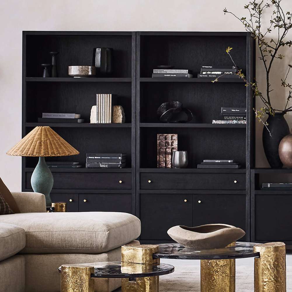 Crate & Barrel Keane 40" Black Wood Storage Bookcase, Set of 2 showcased with open shelves and concealed storage in a designer living room