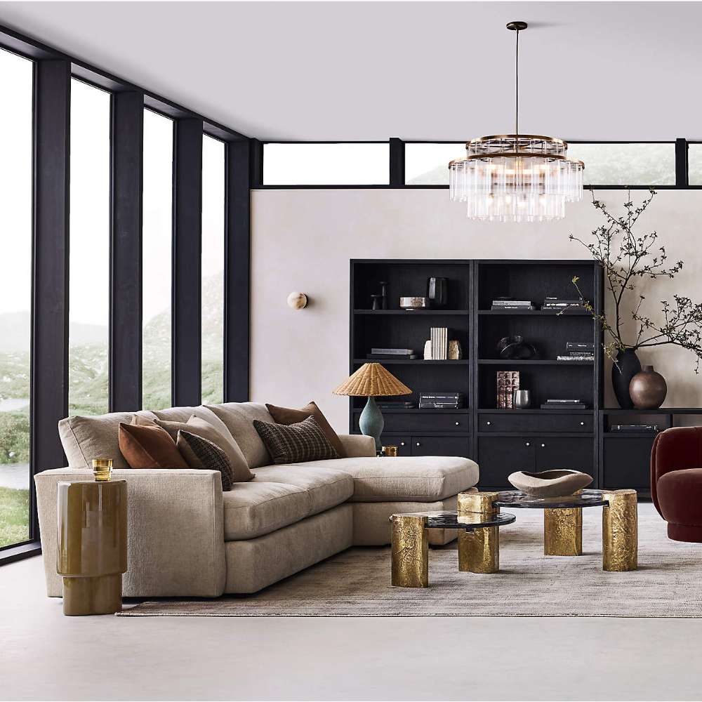Crate & Barrel Keane 40" Black Wood Storage Bookcase, Set of 2 styled behind a modern sofa in a contemporary living room