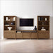 Crate & Barrel Keane 40" Driftwood Storage Bookcase, Set of 2 arranged around a media console and wall-mounted TV
