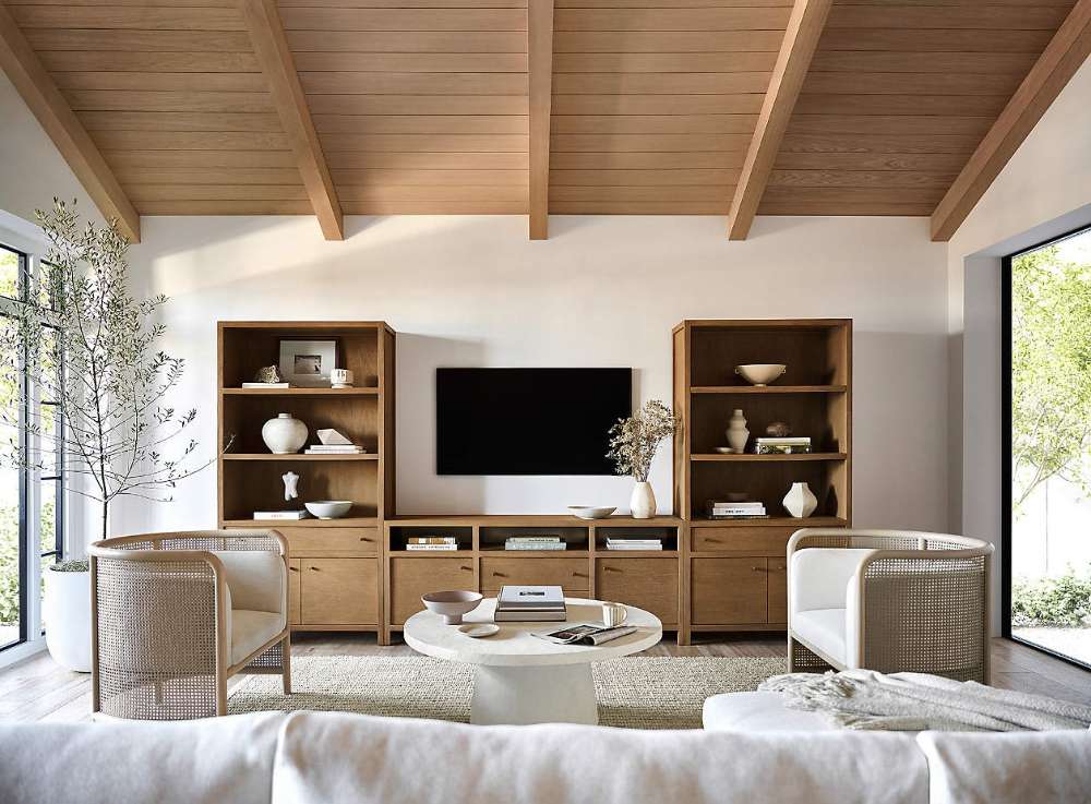 Crate & Barrel Keane 40" Driftwood Storage Bookcase, Set of 2 framing a TV console in a bright, contemporary living space