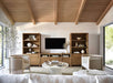 Crate & Barrel Keane 40" Driftwood Storage Bookcase, Set of 2 framing a TV console in a bright, contemporary living space