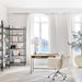 Crate & Barrel Keane 48" Weathered Natural Wood Desk with Outlets styled in a bright home office with a rolling chair and bookshelves