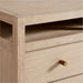 Crate & Barrel Keane 65" Weathered Natural Wood Desk with Outlets detail showing the weathered wood finish, open shelf, and brass-finished drawer pull