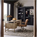 Crate & Barrel Keane 65" Weathered Natural Wood Desk with Outlets styled in a modern home office with a rolling chair and dark bookcases