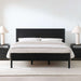 Crate & Barrel Keane Black Solid Wood King Bed styled in a modern bedroom with white bedding, matching black nightstands, and white table lamps