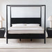 Crate & Barrel Keane Black Solid Wood King Canopy Bed is shown from the front with a sleek black canopy frame, solid wood headboard, and matching nightstands