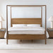 Crate & Barrel Keane Solid Driftwood King Canopy Bed is shown from the front with a slim wood canopy frame, solid headboard, and matching nightstands