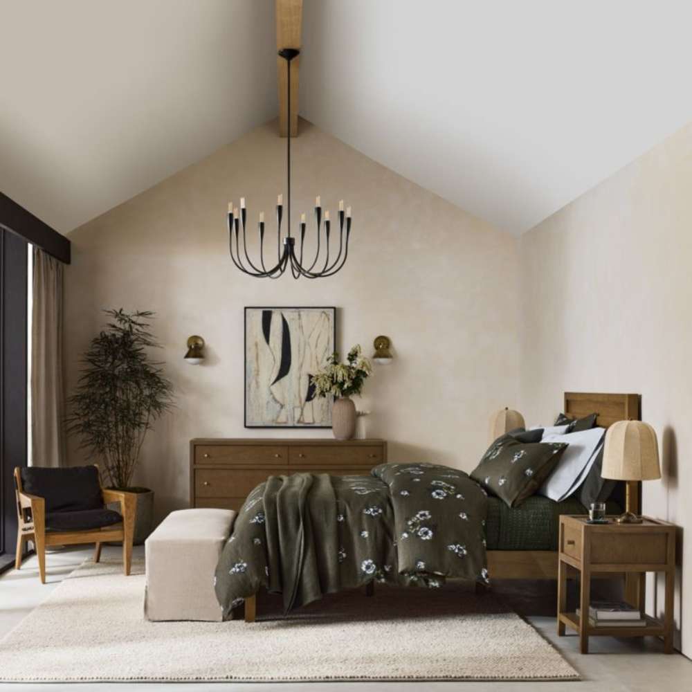 Crate & Barrel Keane Solid Driftwood Queen Bed is displayed in a spacious bedroom with coordinated wood furniture, soft lighting, and neutral decor