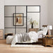 Crate & Barrel Keane Solid Driftwood Queen Bed is styled in a modern bedroom with layered bedding, wood furniture, and minimalist decor