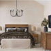 Crate & Barrel Keane Solid Driftwood Queen Bed is styled in an elegant bedroom with dark floral bedding, a bench, and matching wood furniture