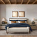Crate & Barrel Keane Weathered Natural Wood Upholstered Queen Bed is shown in a warm bedroom with layered bedding, matching furniture, and an upholstered bench at the foot