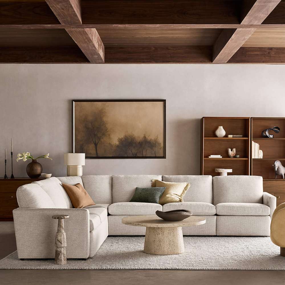Crate & Barrel Lafayette 36" Walnut Open Storage Bookcase displayed in a warm living room with matching walnut furniture, open shelving, and closed storage cabinets