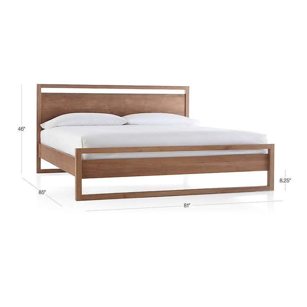 Crate & Barrel Linea Natural Teak Wood King Bed shown with its overall dimensions, featuring a natural teak frame and white bedding on a white background