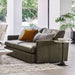 Crate & Barrel Lounge Sofa in a bright modern living room with gray leather upholstery, accent pillows, and a round side table