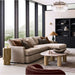 Crate & Barrel Lounge Sofa with a chaise is styled in a modern living room with large windows, layered pillows, and a stone coffee table