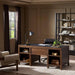 Crate & Barrel Morris 72" Chocolate Brown Writing Desk styled in a home office with open shelves, a desk lamp, books, and a rolling chair