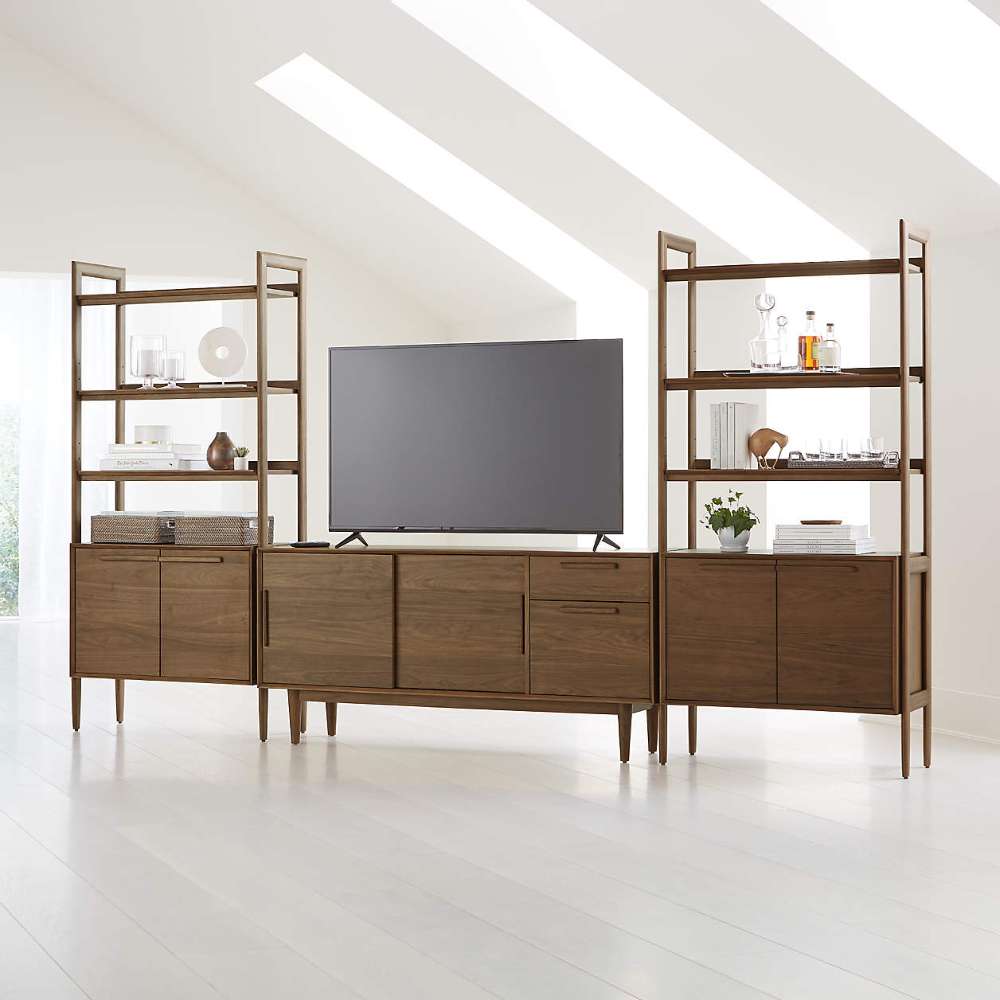 Crate & Barrel Tate 136.5" Walnut Storage Media Console and Bookcase Set styled as a modern entertainment center with a TV and decorative display shelves