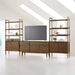 Crate & Barrel Tate 136.5" Walnut Storage Media Console and Bookcase Set styled as a modern entertainment center with a TV and decorative display shelves
