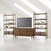 Crate & Barrel Tate 136.5" Walnut Storage Media Console and Bookshelf Set styled as a modern entertainment center with a TV and decorative display shelves