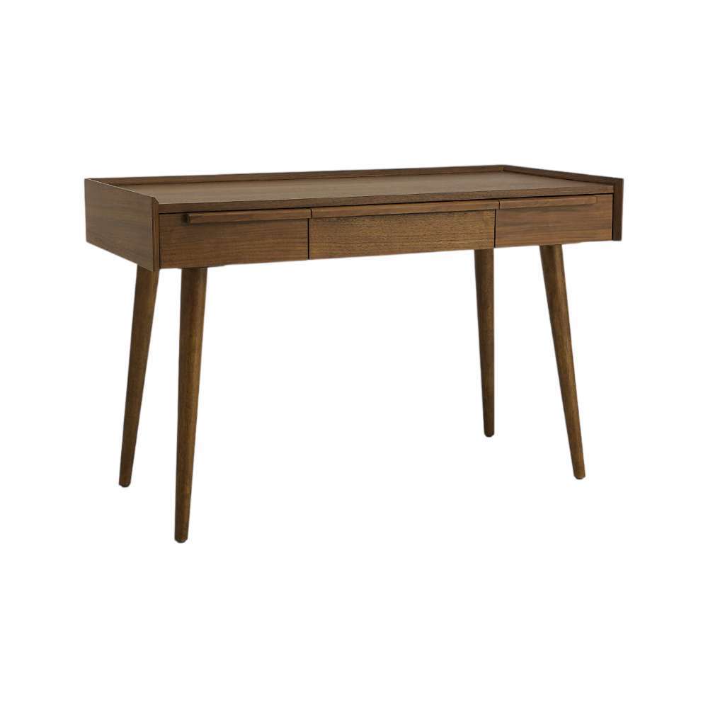 Crate & Barrel Tate 48" Walnut Desk with Outlet displayed at an angle, showcasing its three drawers, tray-edge desktop, and tapered wooden legs