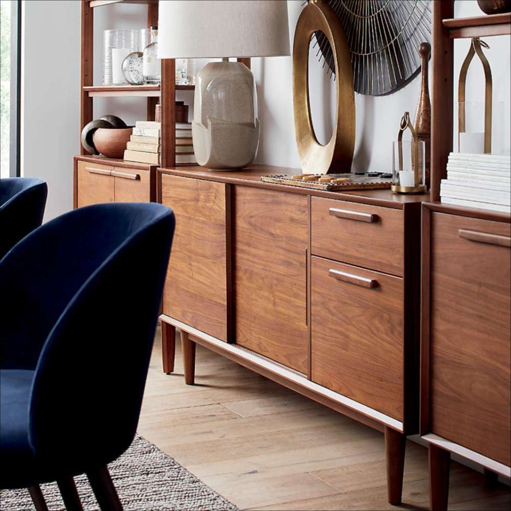 Crate & Barrel Tate 64.5" Walnut Storage Media Console styled with matching walnut furniture in a contemporary workspace