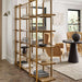Crate & Barrel Thomas Barley Oak Wood Wide Open Bookcase/Room Divider styled as a room divider with books, vases, and decorative accents in a bright living space
