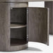 Crate & Barrel Twist 64" Grey Ash Rotating Large Desk with Storage with its cabinet door open, revealing curved interior storage shelves