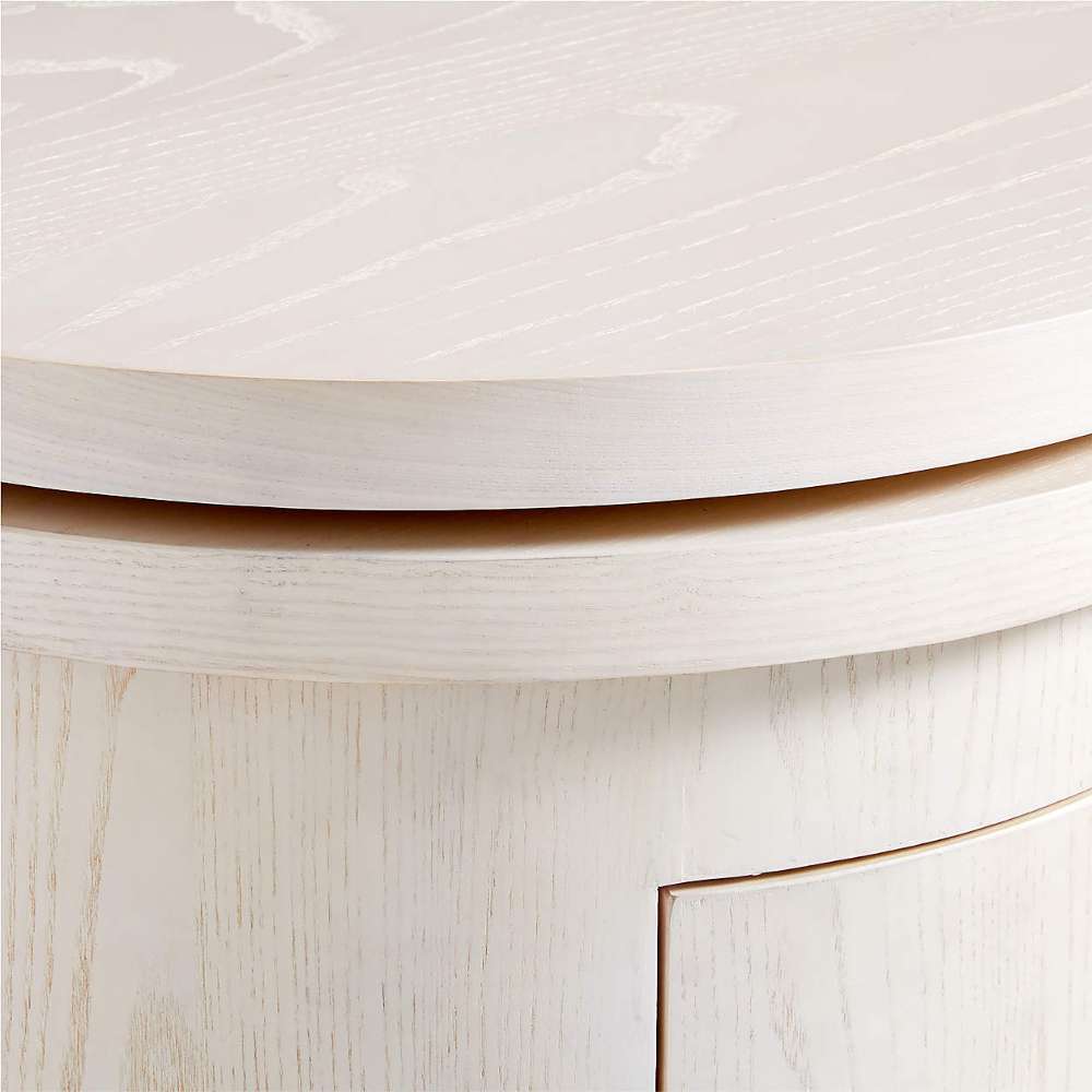 Crate & Barrel Twist 64" Whitewashed Ash Rotating Large Desk with Storage close-up highlighting the rounded desktop edge and whitewashed ash wood grain