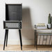 Crosley Bermuda Portable Turntable with Bluetooth InOut - Black set up on a tripod stand in a modern living room