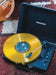 Crosley Cruiser Plus Portable Turntable with Bluetooth InOut - Exclusive Black Vinyl plays a vibrant yellow vinyl