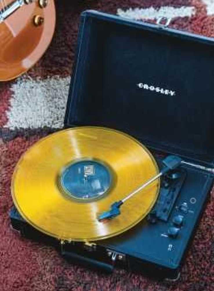 Crosley Cruiser Plus Portable Turntable with Bluetooth InOut - Exclusive Black Vinyl plays a vibrant yellow vinyl