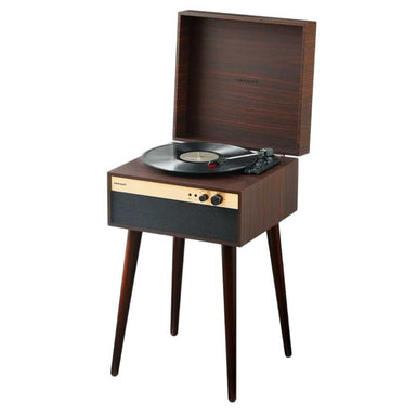 Crosley Jasper Turntable - Walnut is shown standing on sleek wooden legs with its lid open, playing a vinyl record